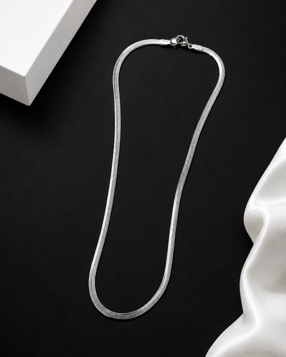Niéche Snake Chain Necklace flat lay with gift box and silk