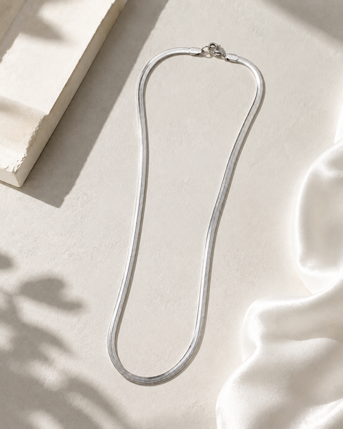 Niéche Snake Chain Necklace flat lay on neutral background