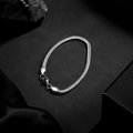 Niéche Snake Chain Bracelet flat lay on black background
